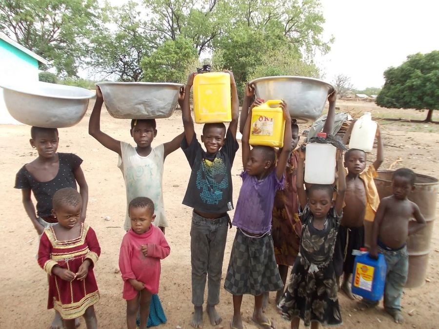 Children collecting water in a partner community